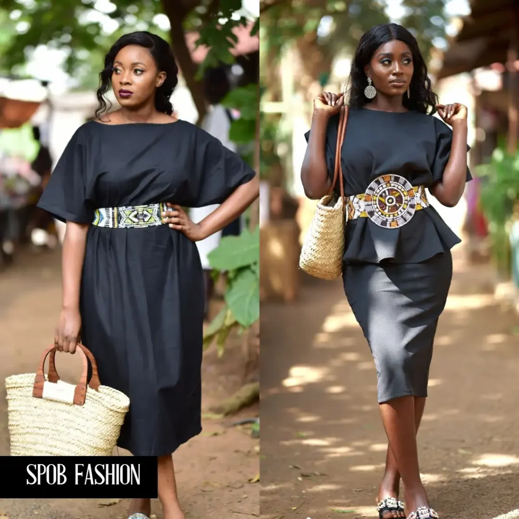 A Black woman in a simple, flowing black midi dress, cinched at the waist with an intricately beaded African waist belt