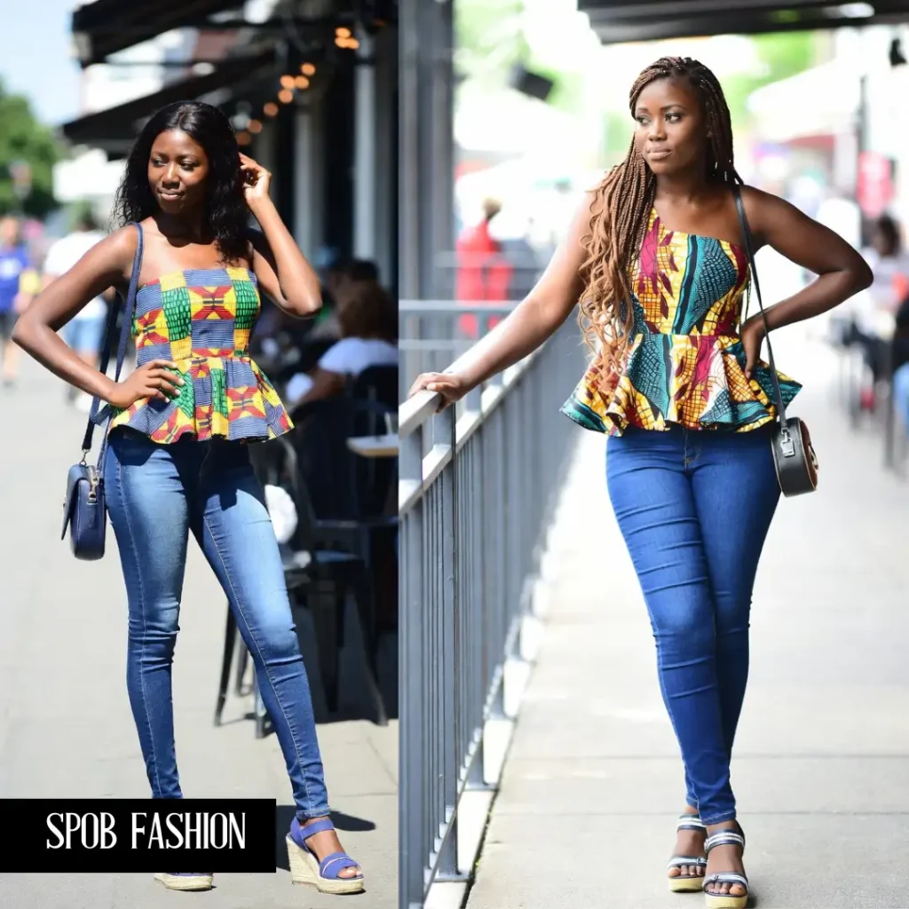 A sophisticated Black woman in dark-wash, tailored jeans, a crisp white button-down shirt, and a chic Adire print blazer.